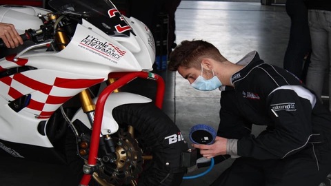 Prise de pression des pneus d'une moto par des techniciens de la compétition moto sur le circuit de Nogaro